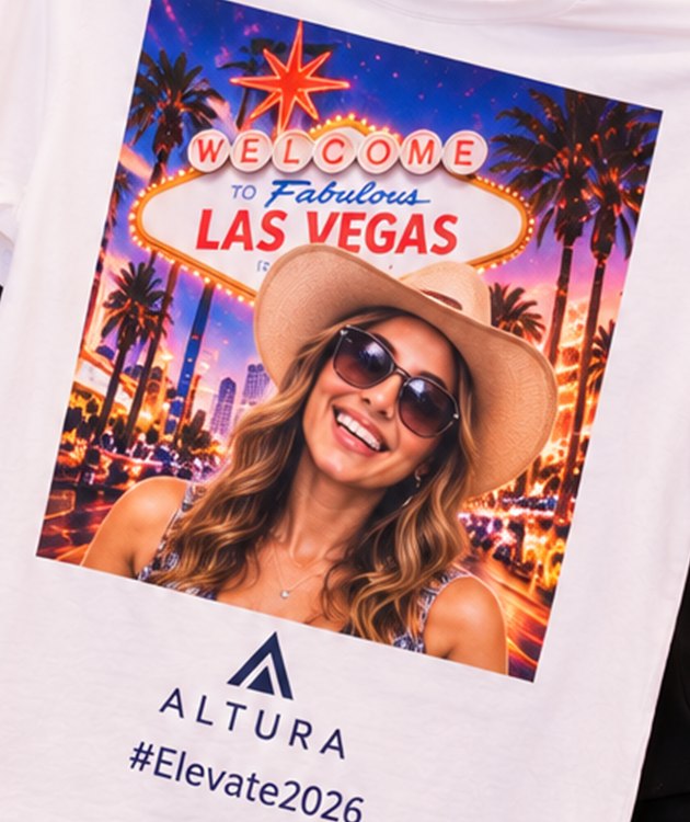 Close-up of a printed AI Las Vegas design with company logo and event hashtag on a white T-shirt